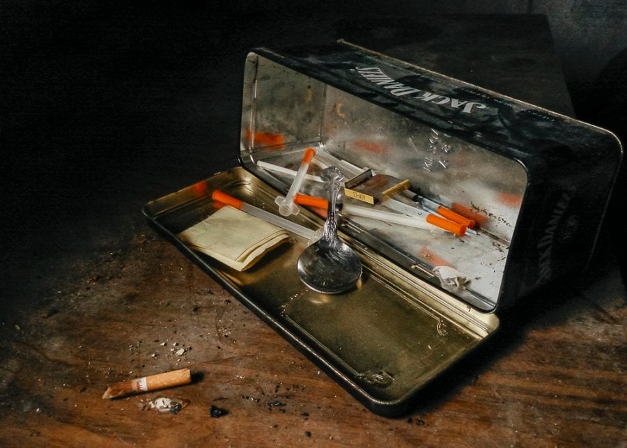 A junky's heroin kit in a Jack Daniels tin at an abandoned house in East Texas