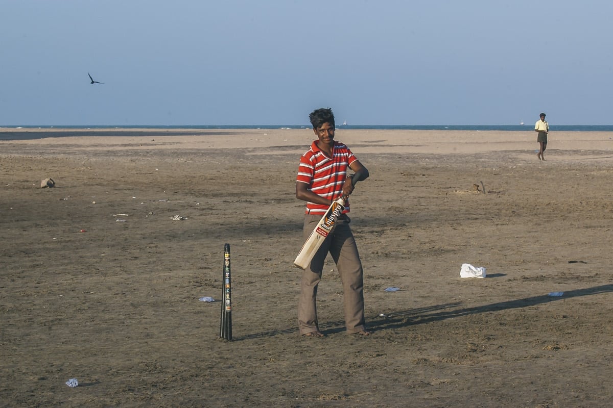 A man playing Cricket on Nagapattinam Beach