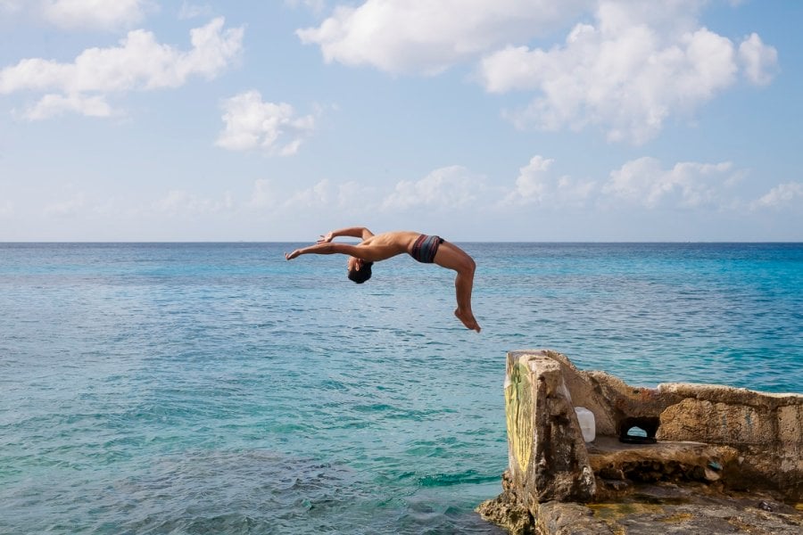 A guy doing a back flip in Cozumel