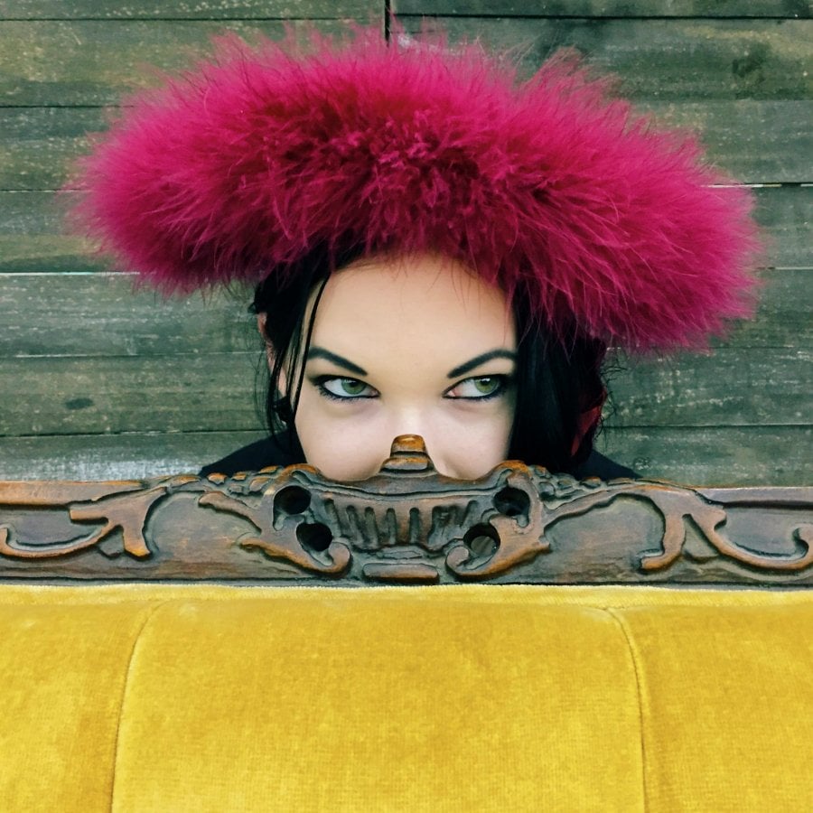 Photos People Remember: Woman peeking from behind a yellow couch