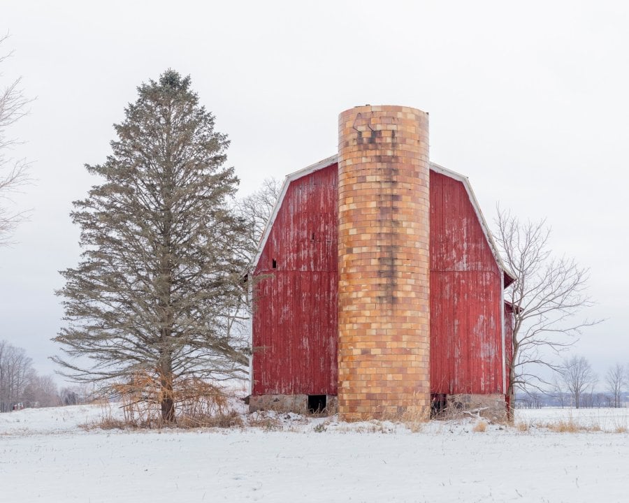 Old Red Dutch barn covered with snow