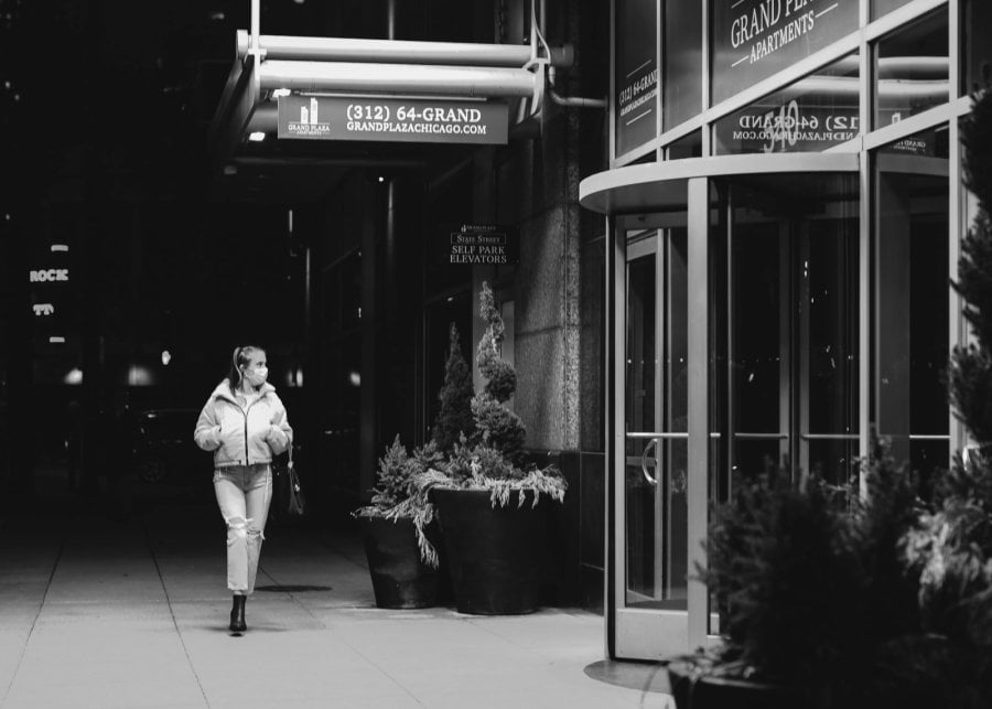 Woman walking in downtown Chicago at Night