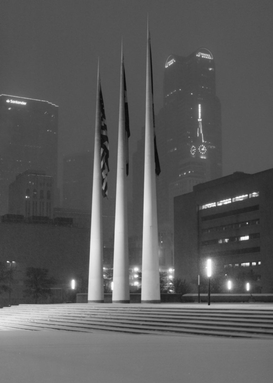 City of Dallas flag posts at night in the snow