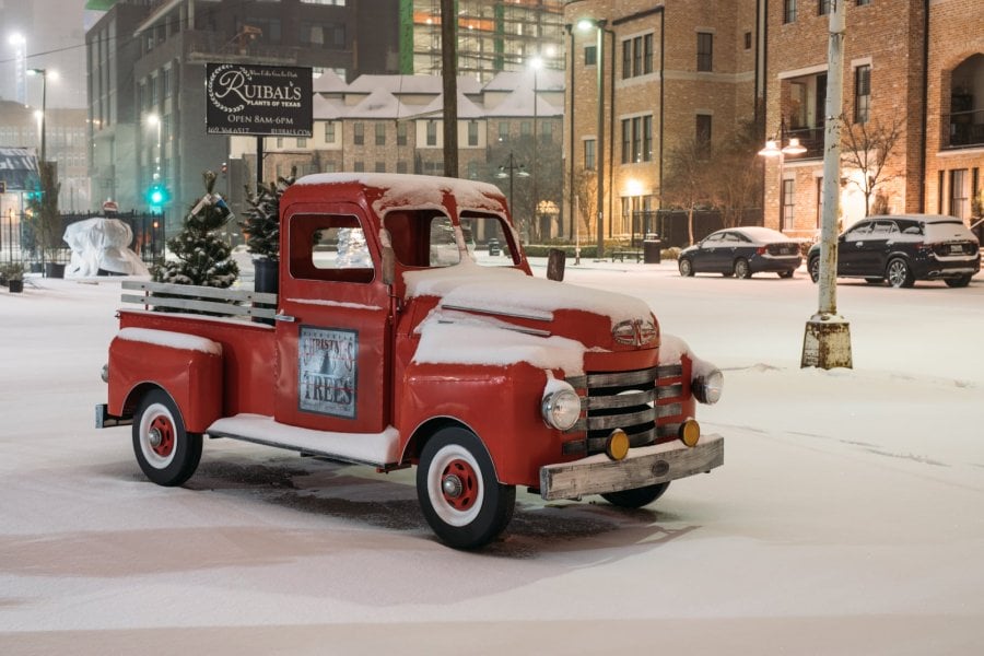 Old red pickup covered with snow in the Farmers Market in Dallas
