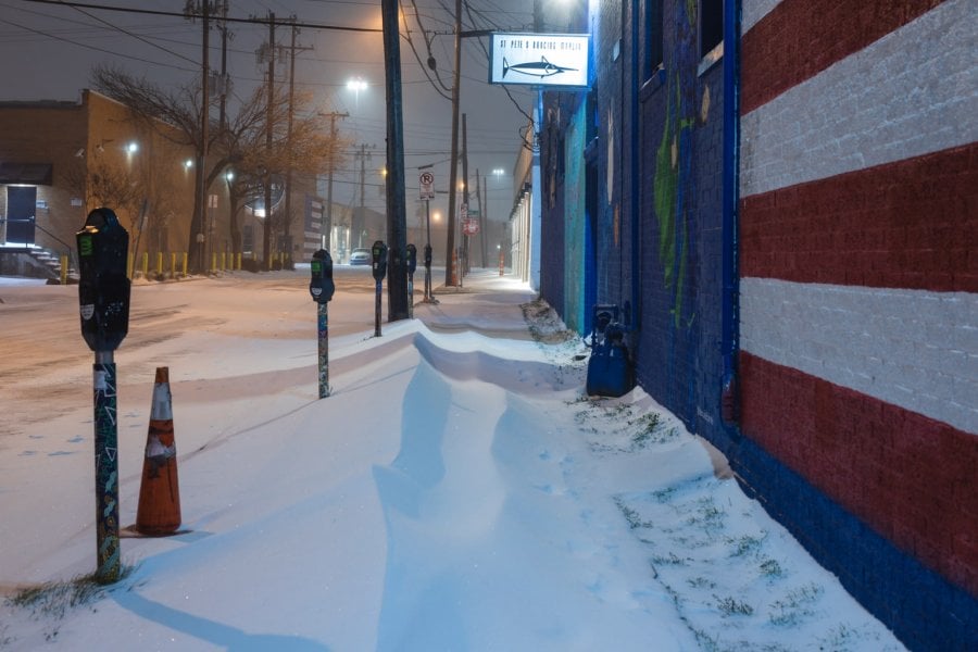 Snow piled up on the sidewalk in Deep Ellum