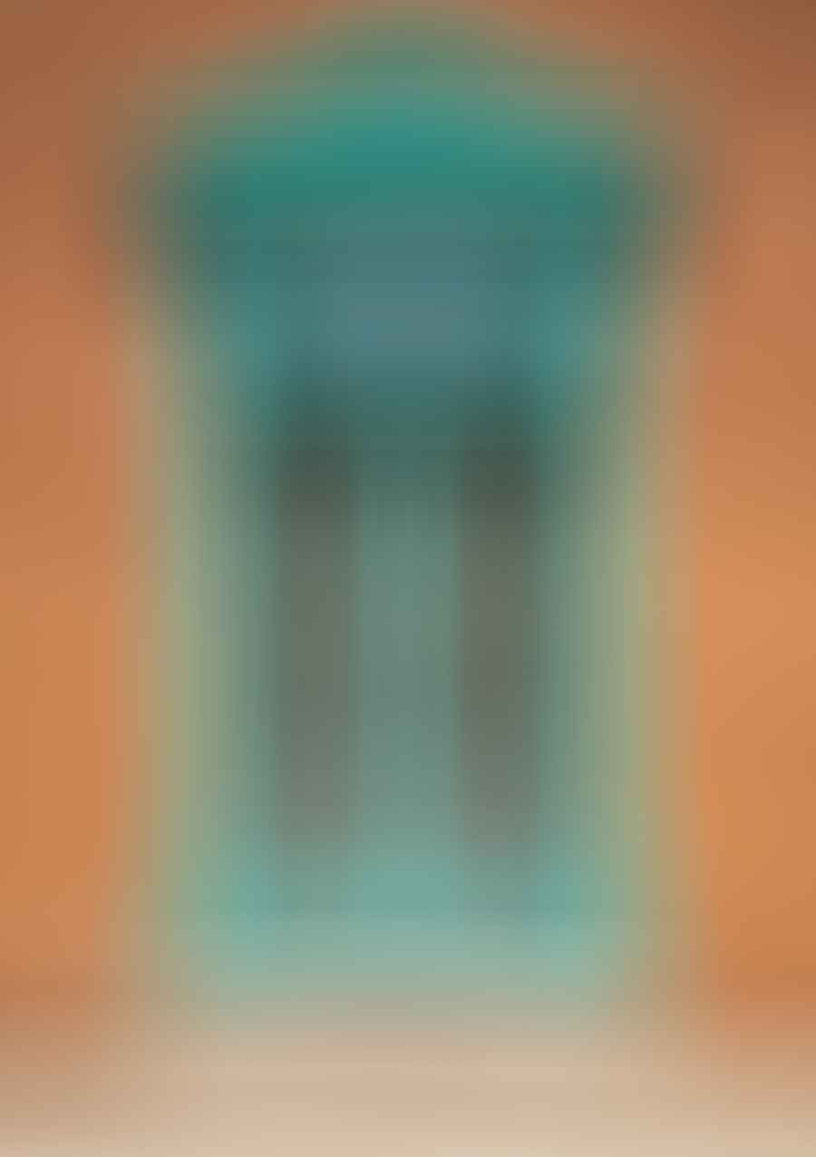 A turquoise window frame in an adobe style building