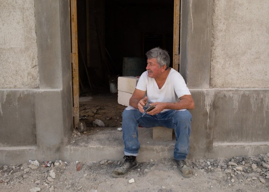 A construction worker sitting and taking a break