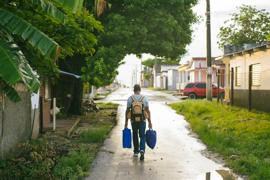 A man carrying groceries in Antonio De Las Vueltas, Cuba