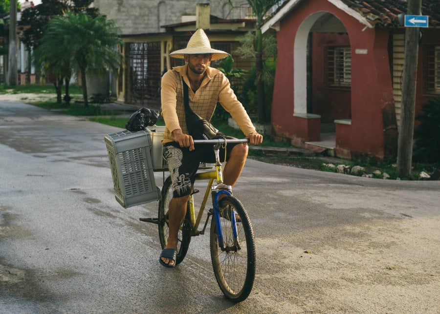 A man riding a bike in Antonio De Las Vueltas, Cuba