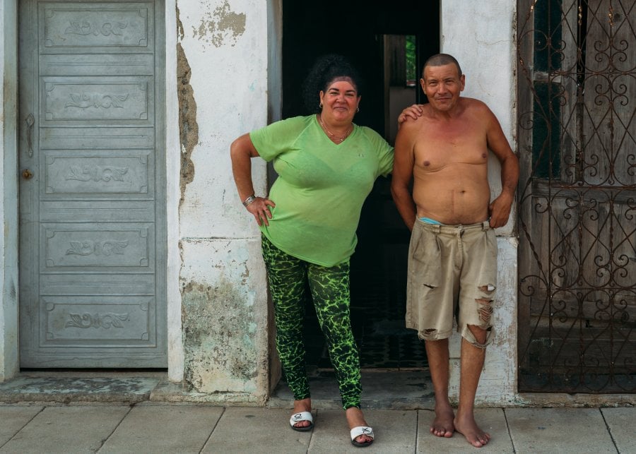 A couple standing outside of their home in Antonio De Las Vueltas, Cuba
