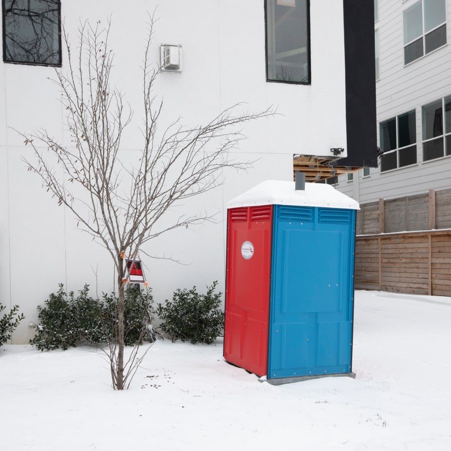 a colorful porta potty in the snow