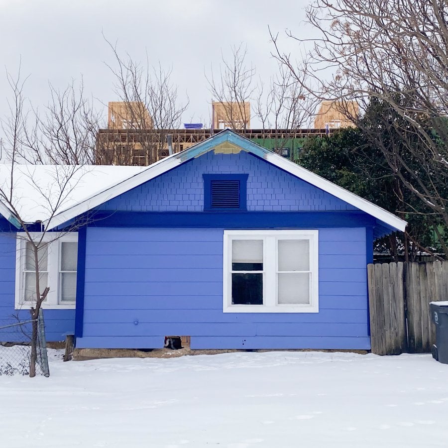 A blue house in the snow in Old East Dallas